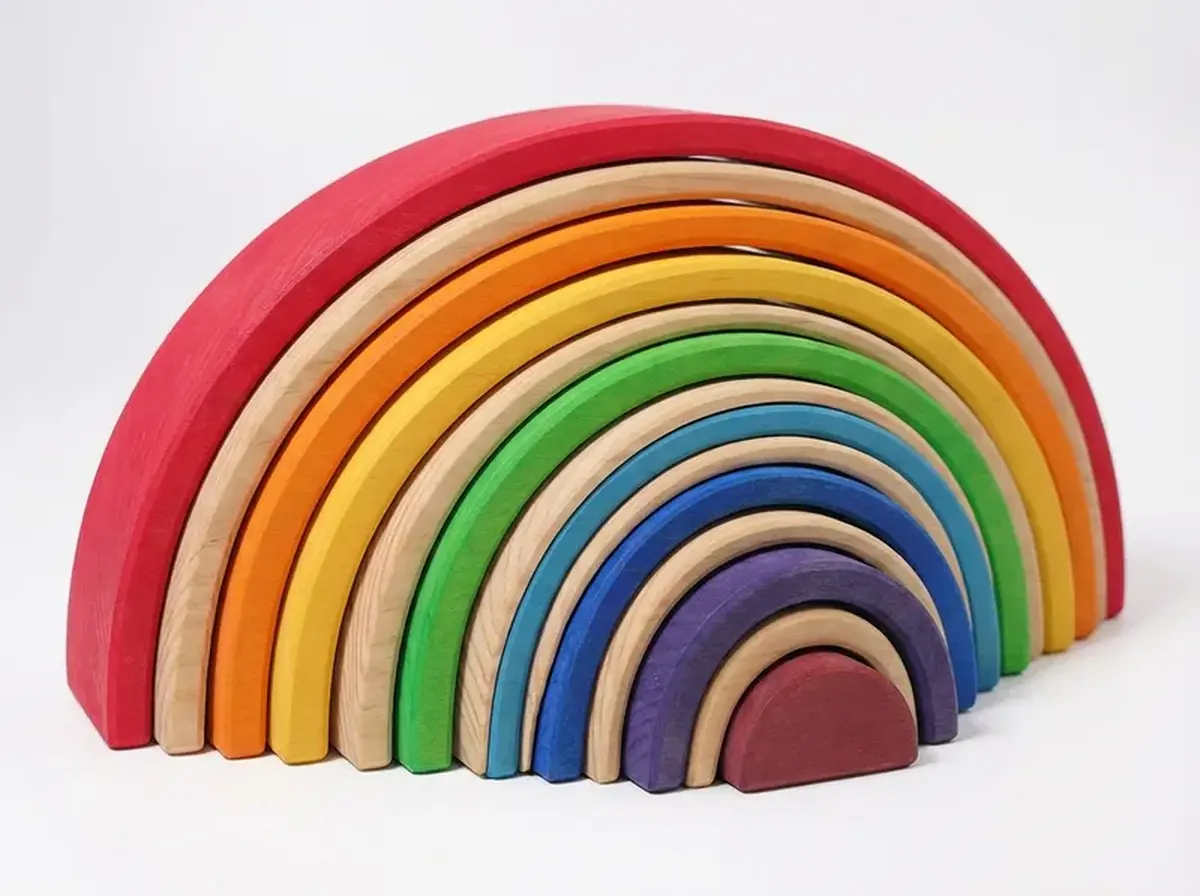 Grimm's Rainbow Stacker used as an open-ended wooden building toy