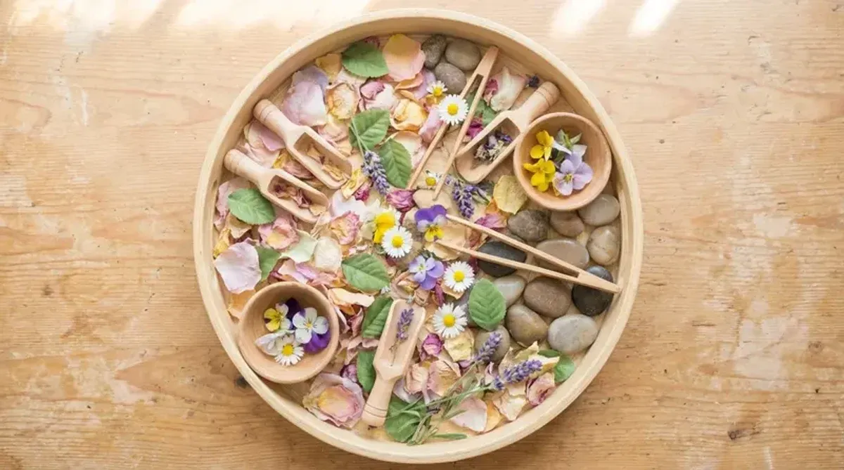 Spring Montessori sensory tray with natural materials sorted for toddler exploration
